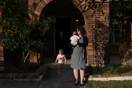 Lauren, Asa and Micah Hoffmann are seen outside their home before posing for a portrait in San Antonio, Texas, U.S., February 13, 2019. REUTERS/Callaghan O'Hare