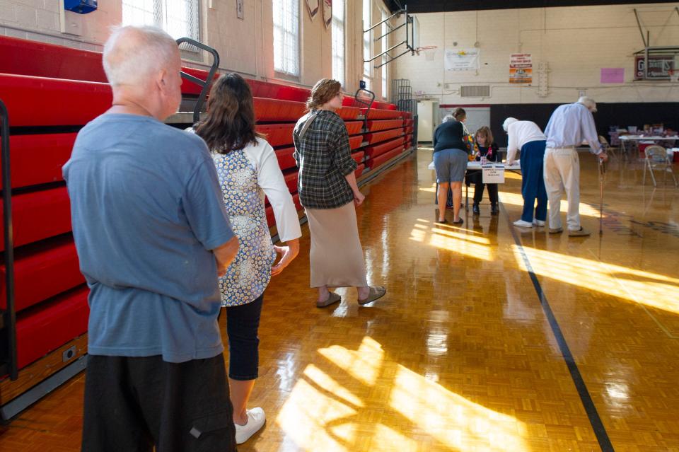 People stand in line waiting to vote in Knoxville city elections at Gresham Middle School on Nov. 7, 2023.