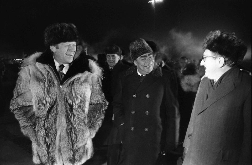 US president Gerald Ford, Soviet general secretary Lenoid Brezhnev and Kissinger speaking informally at the conclusion of the Vladivostok Summit on the tarmac at Vozdvizhenka Airport in November 1974 (Universal History Archive/Getty)
