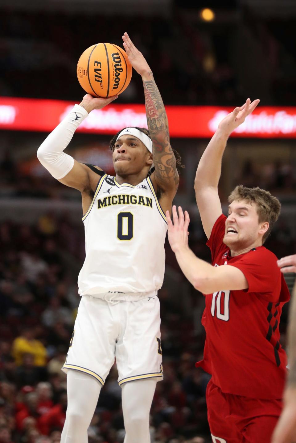 Michigan Wolverines guard Dug McDaniel (0) shoots against Rutgers Scarlet Knights guard Cam Spencer (10) during second half action of the Big Ten Tournament March 9, 2023.