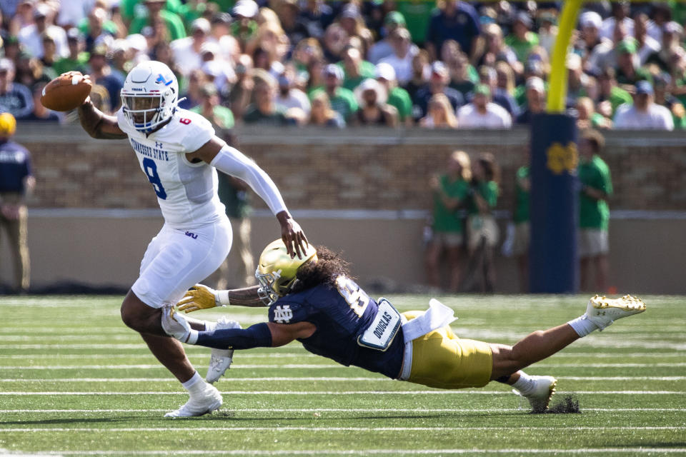 Tennessee State's Deveon Bryant, left, breaks a tackle by Notre Dame's Marist Liufau, right, during the first half of an NCAA college football game on Saturday, Sept. 2, 2023, in South Bend, Ind. (AP Photo/Michael Caterina)