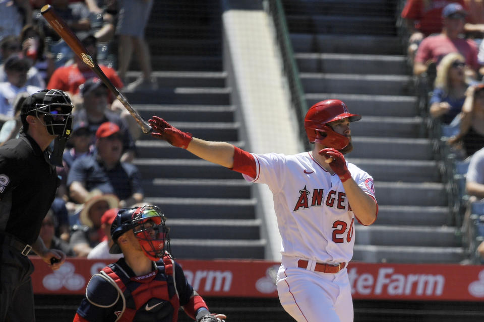 Los Angeles Angels' Jared Walsh, right, hits a solo home run as Boston Red Sox catcher Christian Vazquez, center, and home plate umpire Adam Beck watch during the fifth inning of a baseball game Wednesday, July 7, 2021, in Anaheim, Calif. (AP Photo/Mark J. Terrill)