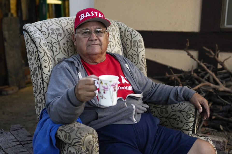 Ron Flores, a Republican, sits on his porch, Thursday, Nov. 3, 2022, in Huntington Beach, Calif. Flores is retired and helps campaign for conservative candidates. (AP Photo/Ashley Landis)