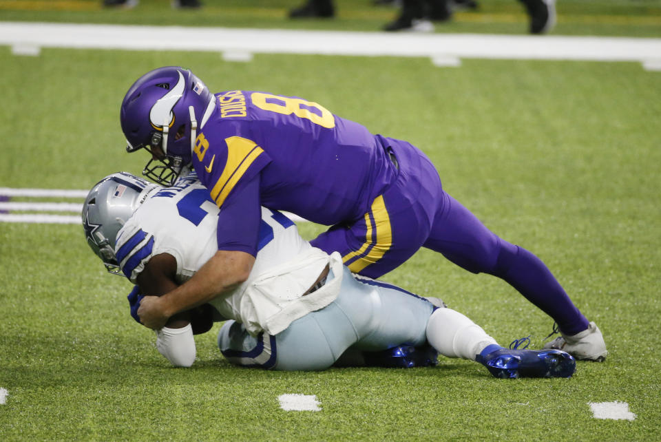 Dallas Cowboys safety Donovan Wilson recovers a fumble by Minnesota Vikings quarterback Kirk Cousins, right, during the first half of an NFL football game, Sunday, Nov. 22, 2020, in Minneapolis. (AP Photo/Bruce Kluckhohn)