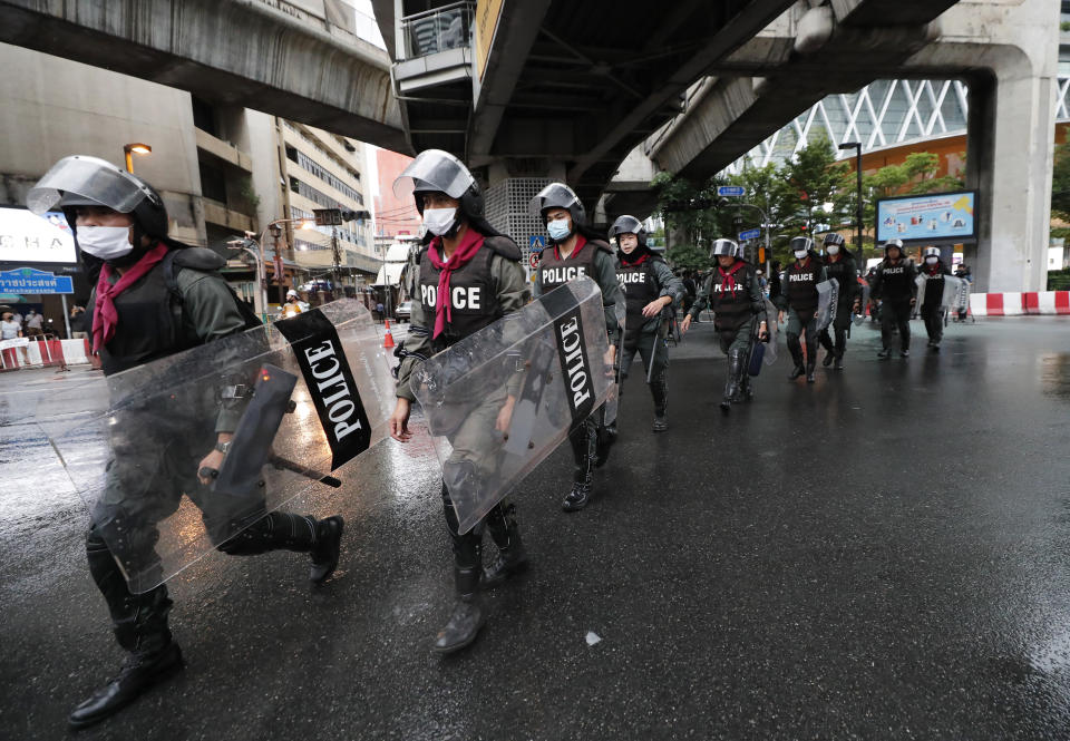 Thai police with riot shields take position in a business district where anti-government protesters sayid they will meet in Bangkok, Thailand, Friday, Oct. 16, 2020. Police announced Friday they would block roads leading to Bangkok’s Rajprasong intersection, where Thursday's rally was held, after protesters called on supporters to mass again. (AP Photo/Sakchai Lalit)