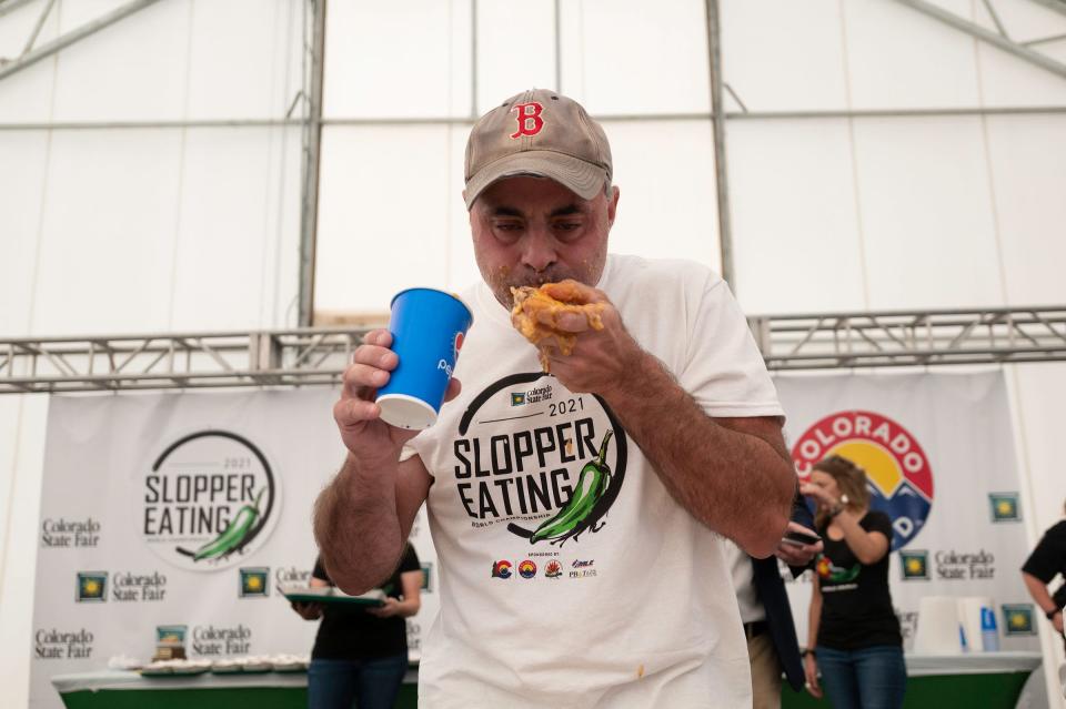 Geoffrey Esper forces down one of 34 sloppers to take the title at the 2021 World Slopper Eating Championship during the Colorado State Fair on Saturday September 4, 2021.