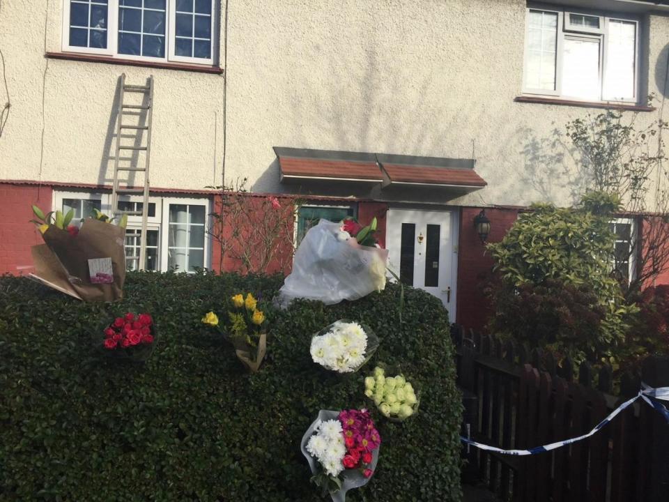 Murder scene: Floral tributes outside a house on Hill Road, Muswell Hill (PA)