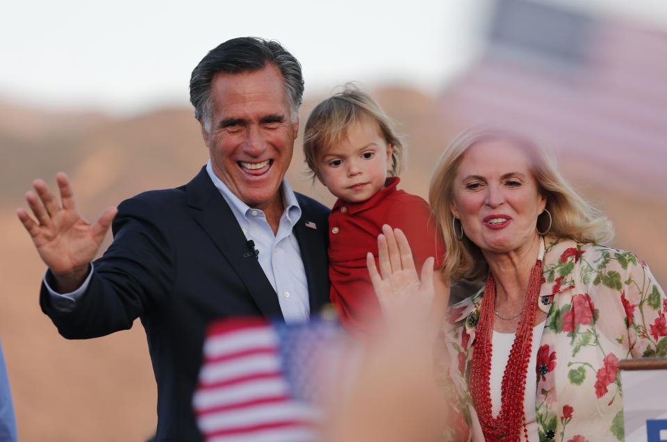 FILE - Former GOP presidential nominee Mitt Romney holds his grandson Dane Romney, 2, while he and his wife, Ann, wave after addressing supporters at their campaign headquarters during an election night party, June 26, 2018, in Orem, Utah. (AP Photo/Rick Bowmer, File)