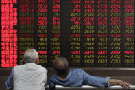 Investors chat as they monitor stock prices at a brokerage house in Beijing, Wednesday, May 22, 2019. Shares edged in Asia on Wednesday after a rebound in technology stocks helped power an overnight rally on Wall Street. (AP Photo/Andy Wong)