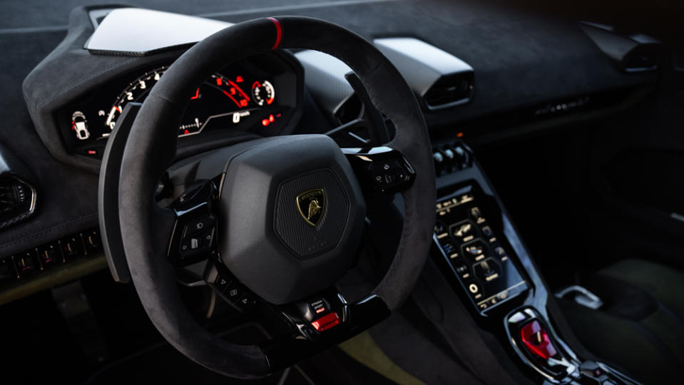 A close-up of the steering wheel and dash of the Lamborghini Huracán Sterrato.