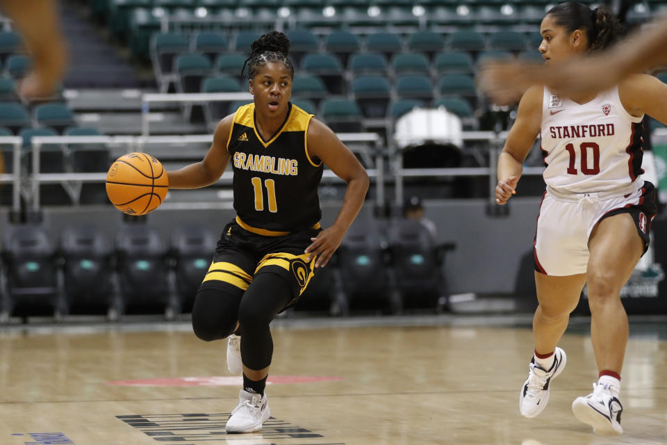 Grambling State guard Colbi Maples (11) tries to get around Stanford guard Talana Lepolo (10) during the first quarter of an NCAA college basketball game, Saturday, Nov. 26, 2022, in Honolulu. (AP Photo/Marco Garcia)