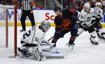 Los Angeles Kings goalie Jonathan Quick, left, kicks away a loose puck as Edmonton Oilers right wing Kailer Yamamoto closes in during the second period in Game 7 of a first-round series in the NHL hockey Stanley Cup playoffs Saturday, May 14, 2022, in Edmonton, Alberta. (Jeff McIntosh/The Canadian Press via AP)