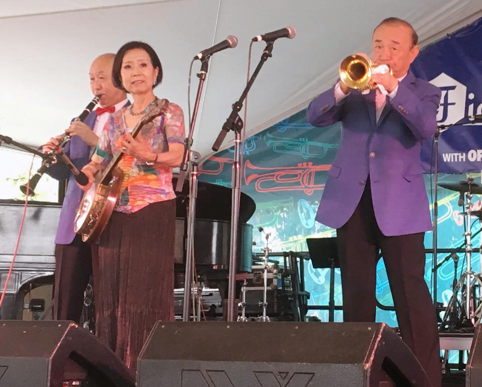 Jazz musician Yoshio Toyama, second from right, plays with wife Keiko Toyama and other members of the Dixie Saints in New Orleans on Saturday, Aug. 4, 2018. Known as the "Japanese Sachmo" for his devotion to jazz great Louis Armstrong, Toyama and the group played at Satchmo Summerfest, held annually to mark Armstrong's birthday. (AP Photo/Jay Reeves)