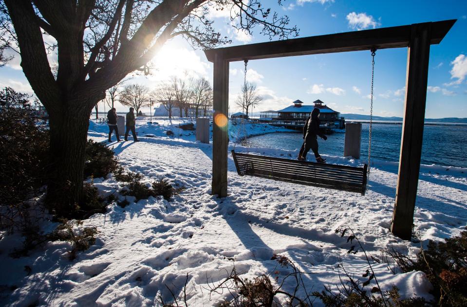 Pedestrians brave cold weather for a stroll along the boardwalk at Waterfront Park in Burlington on Wednesday, December 27, 2017.