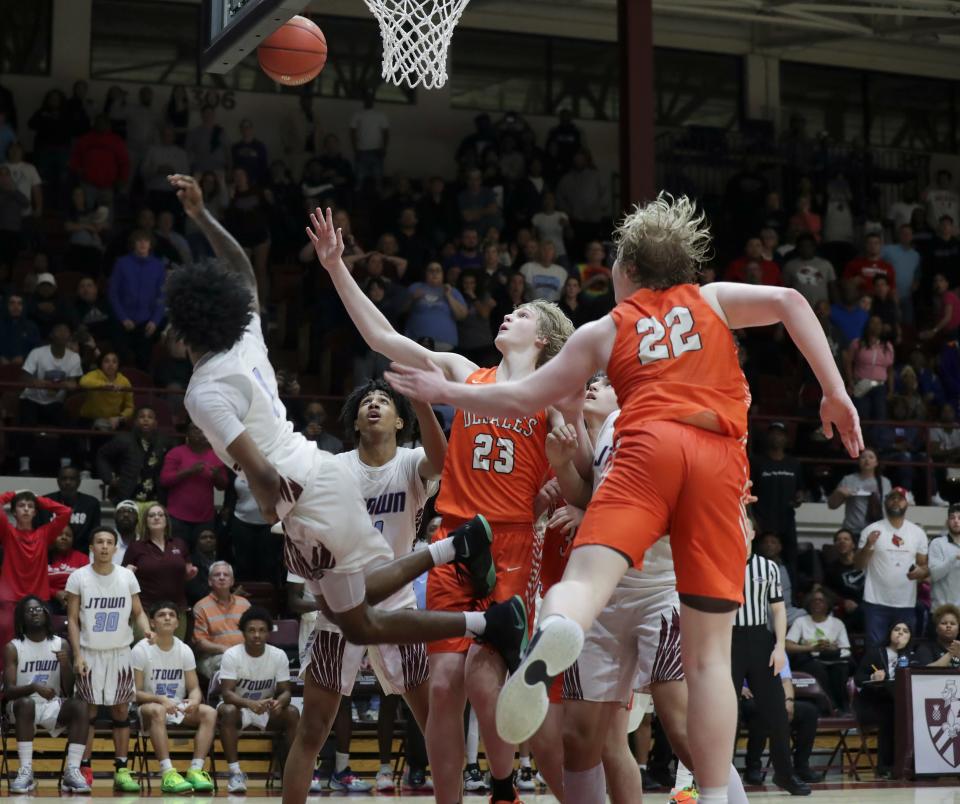 J-Town's Brandon Gatewood (1) hit an acrobatic layup against Desales to take the lead 55-54 with 8.1 seconds left during the championship of the 6th Region tournament at Bellarmine Knights Hall in Louisville, Ky. on Mar. 6, 2023.