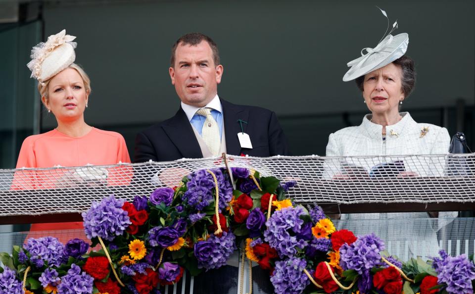 Lindsay Wallace, Peter Phillips and Princess Anne, Princess Royal watch the racing from the royal box as they attend The Epsom Derby at Epsom Racecourse on June 4, 2022 in Epsom, England.