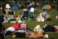 A person sleeps in the queue before the start of day one of the Wimbledon tennis championships in London, Monday, June 27, 2022. (Aaron Chown/PA via AP)