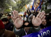 An Indian raises his tied hands and shoutS slogans during a protest against the Citizenship Amendment Act in New Delhi, India, Friday, Dec. 27, 2019. Tens of thousands of protesters have taken to India's streets to call for the revocation of the law, which critics say is the latest effort by Narendra Modi's government to marginalize the country's 200 million Muslims. (AP Photo/Manish Swarup)