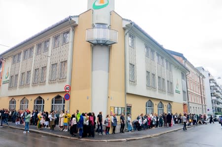 People gather outside the Islamic Cultural Centre to show solidarity with the Muslim community after Saturday's shooting at a mosque, in Oslo