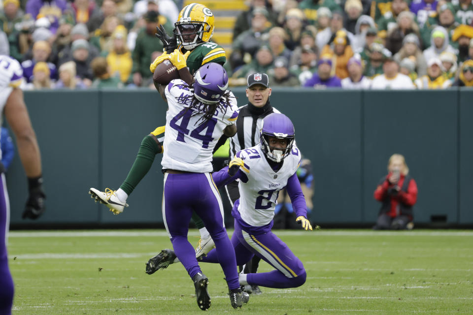 Green Bay Packers wide receiver Jayden Reed (11) attempts to catch a pass that would be intercepted by Minnesota Vikings safety Josh Metellus (44) during the second half of an NFL football game Sunday, Oct. 29, 2023, in Green Bay, Wis. (AP Photo/Mike Roemer)