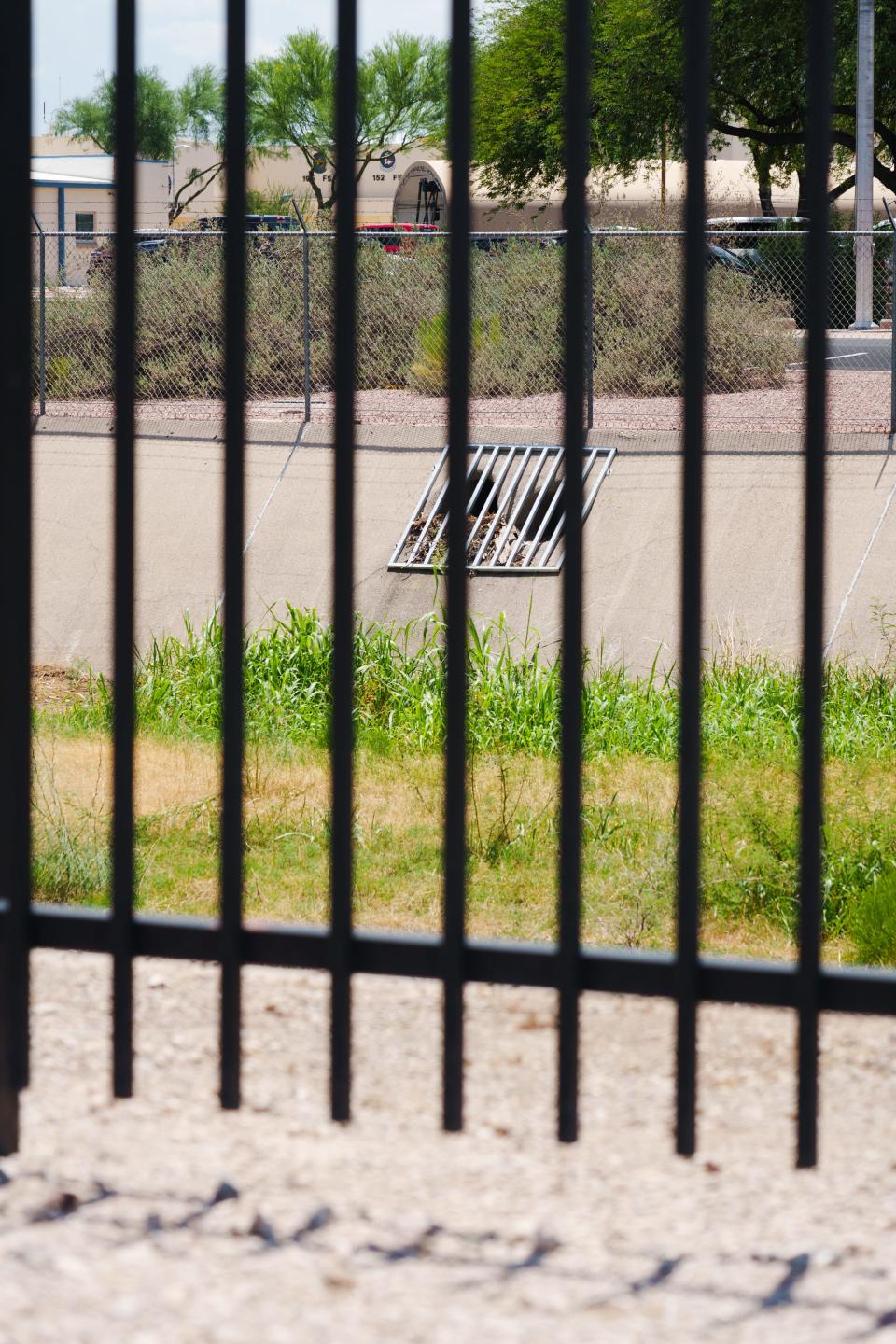 A drain leads into Airport Wash inside Morris Air National Guard Base, photographed from Valencia road in Tucson, AZ on July 15, 2022. The wash also runs through the Tucson Airport and connects to the Santa Cruz River.