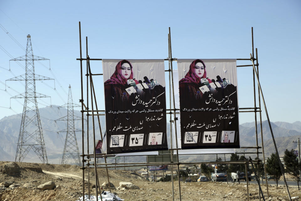 In this Sunday, Oct. 14, 2018 photo, campaign billboards for Parliamentary candidate Hameeda Danesh, are displayed along a roadside, in Wardak province, central Afghanistan. Danesh says Saturday’s elections in Afghanistan are key to countering the conservatism that stifles education, other opportunities for women. (AP Photo/Rahmat Gul)
