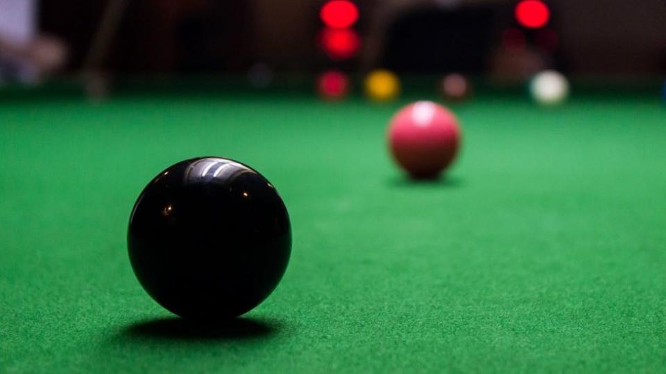 Black Snooker ball on table