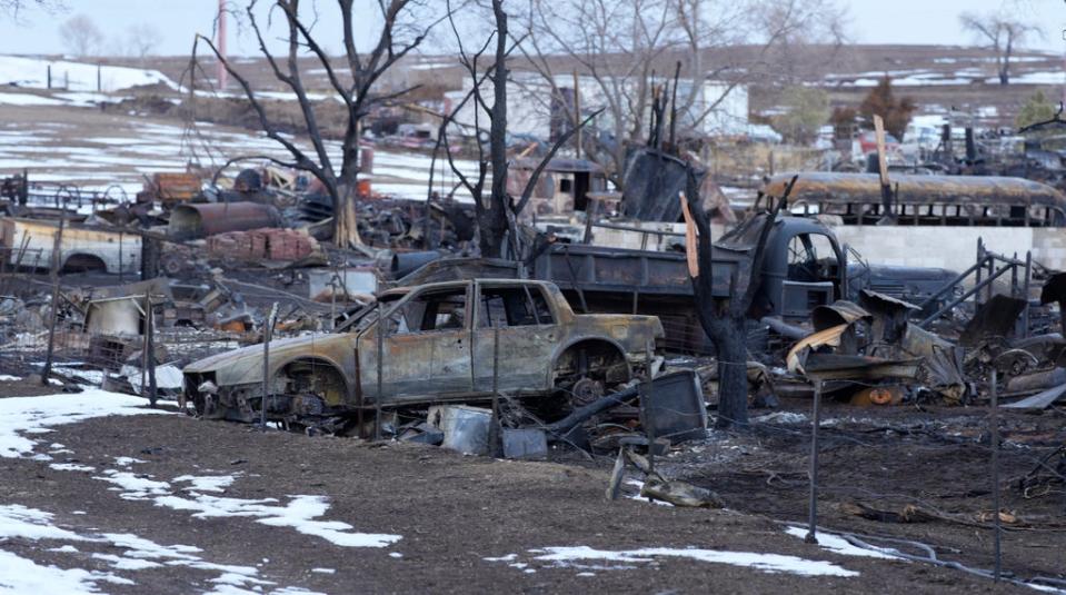 Charred vehicles sit amid the remains of home in the 1500 block of South 76th, Friday, Jan. 14, 2022, in Superior, Colo. (Copyright 2022 The Associated Press. All rights reserved.)