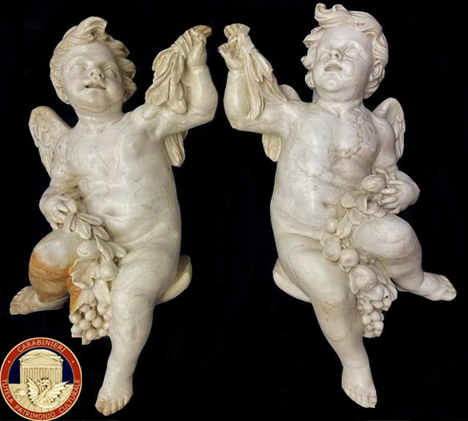 Two marble statues of angels are seen in this undated image. A British art collector who bought a pair of 17th century marble angels from a Neapolitan antiques shop two decades ago and had them at his French home has returned the “putti” to Italy’s art police after learning that they had been stolen from a church. In a statement released Tuesday Oct. 19, 2021 Italy’s carabinieri art police said the unnamed collector had tried to resell the angels at an antiques shop in Avignon, France ahead of his planned move from France to Portugal when French art police identified them as possible stolen goods. (Carabinieri for the Protection of Cultural Heritage via AP)