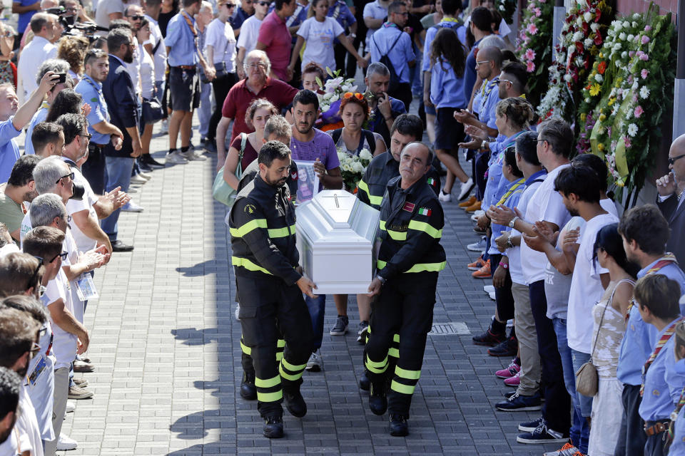 <p>Firefighters carry the coffin of 9-year-old Giulia Rinaldo outside the gymnasium where the state funeral service for some of the victims of the earthquake that hit central Italy last Wednesday took place, in Ascoli Piceno, Italy, Aug. 27, 2016. Italians bid farewell Saturday to victims of the devastating earthquake that struck a mountainous region of central Italy this week. (AP Photo/Gregorio Borgia) </p>