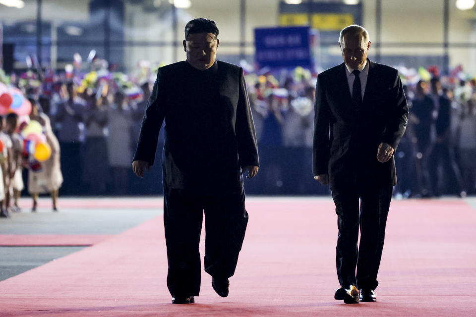 Russian President Vladimir Putin, right, and North Korea's leader Kim Jong Un walk together during the departure ceremony at an international airport outside Pyongyang, North Korea, on Wednesday, June 19, 2024. (Gavriil Grigorov/Sputnik, Kremlin Photo via AP)