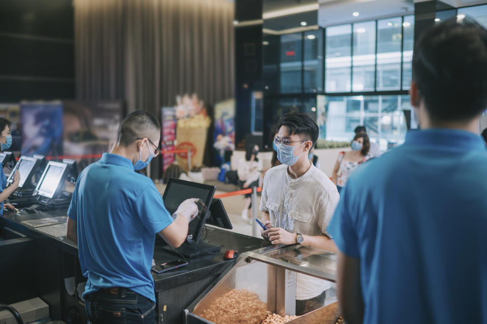 People purchasing food at a concessions stand at the movies