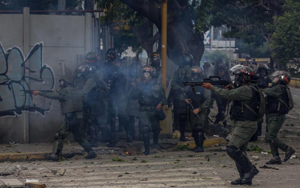 Opposition sympathizers clash with Venezuela security forces during a protest in Caracas, Venezuela - Credit: Cristian Hernandez /EFE