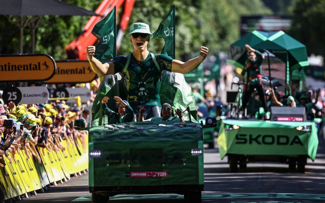 The publicity caravan drives past the finish line