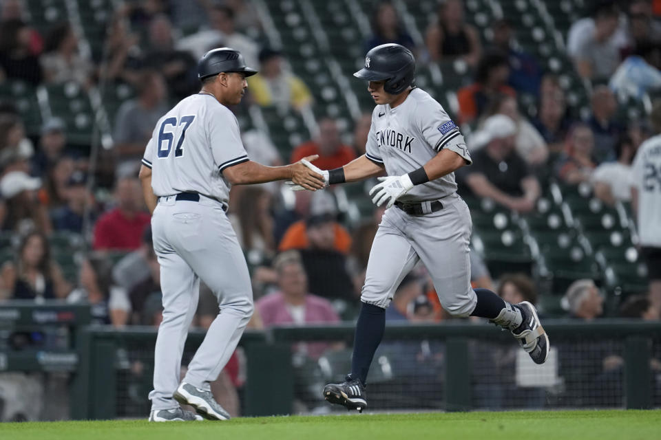 New York Yankees' Anthony Volpe, right, celebrates his home run with third base coach Luis Rojas (67) against the Detroit Tigers in the ninth inning of a baseball game, Tuesday, Aug. 29, 2023, in Detroit. (AP Photo/Paul Sancya)