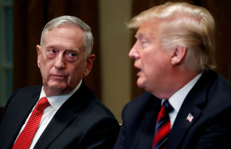 FILE PHOTO: U.S. Defense Secretary James Mattis listens as U.S. President Donald Trump speaks to the news media while gathering for a briefing from his senior military leaders in the Cabinet Room at the White House in Washington, U.S., October 23, 2018. REUTERS/Leah Millis/File Photo