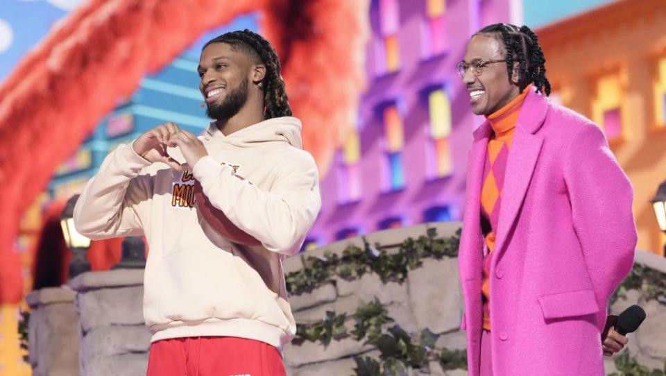 THE MASKED SINGER: L-R: Damar Hamlin and host Nick Cannon in the “Sesame Street Night” episode of THE MASKED SINGER airing Wednesday, March 15 (8:00-9:01 PM ET/PT) on FOX. CR: Michael Becker/FOX ©2023 FOX Media LLC.