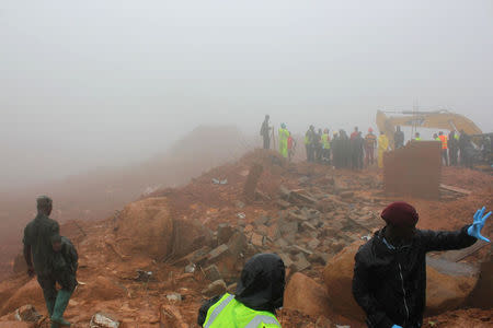 Rescue workers search for survivors after a mudslide in the mountain town of Regent, Sierra Leone August 14, 2017. REUTERS/Ernest Henry