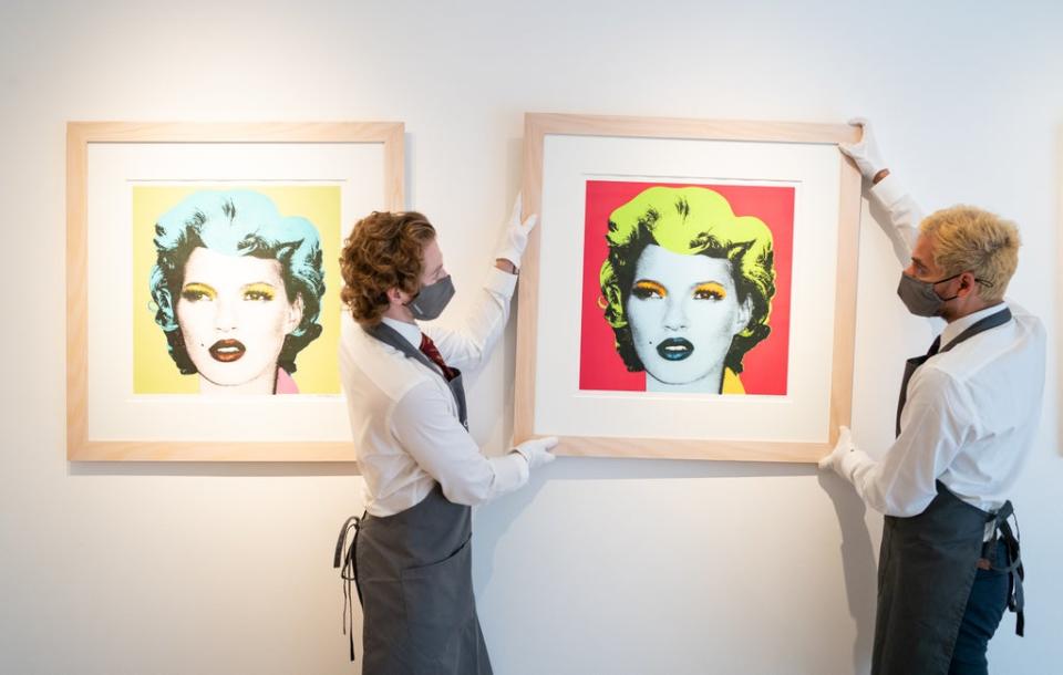 Christie’s art handlers adjust prints of Kate Moss by Banksy, which are also included in the sale (Dominic Lipinski/PA) (PA Wire)