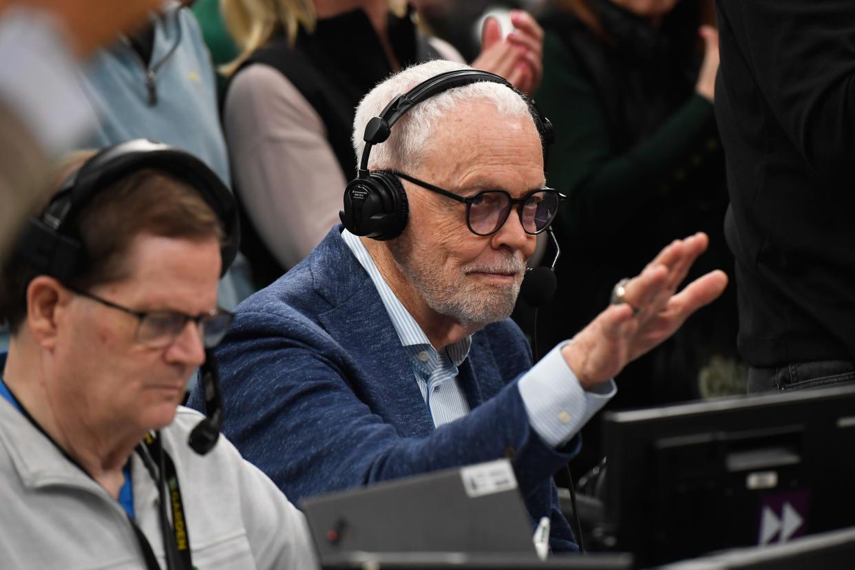 Celtics play by play announcer Mike Gorman waves to the crowd at Boston's TD Garden during a timeout in a game against the Washington Wizards on April 14, which was designated "Mike Gorman Day" by Boston mayor Michelle Wu.