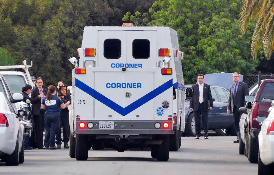 In this Tuesday, Dec. 20, 2016, file photo, police and coroner's officials investigate a home in the Lennox area of Los Angeles as they search for Lisa Marie Naegle, who has been missing since the previous weekend.