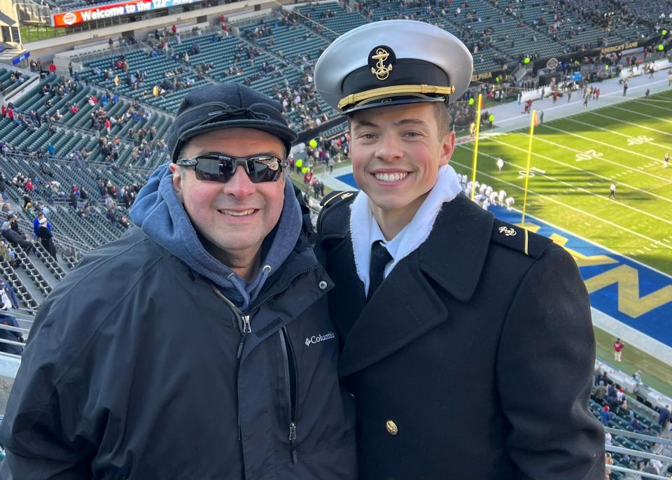 Rick Dupon, of Houghton Lake, the president of Michigan's Naval Academy Parents Club, with his son, Colin Dupon, a Naval Academy midshipman, at the Army-Navy game in 2023 at Lincoln Financial Field Stadium in Philadelphia.