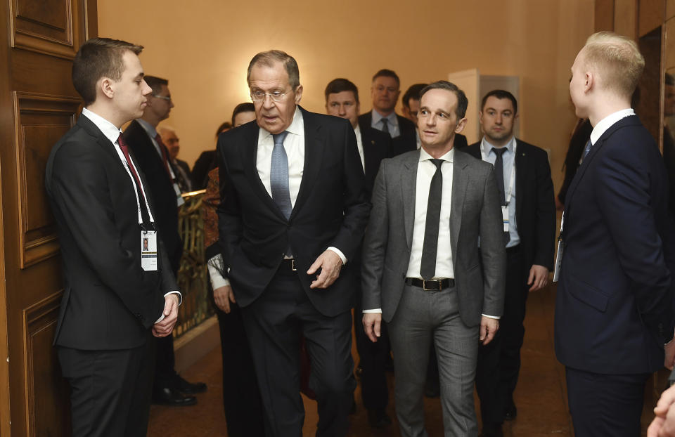 Sergei Lavrov, Foreign Minister of Russia, 2nd from left, and his German counterpart Heiko Maas meet for breakfast on the second day of the 56th Munich Security Conference in Munich, Germany, Saturday, Feb.15, 2020. (Tobias Hase/dpa via AP)