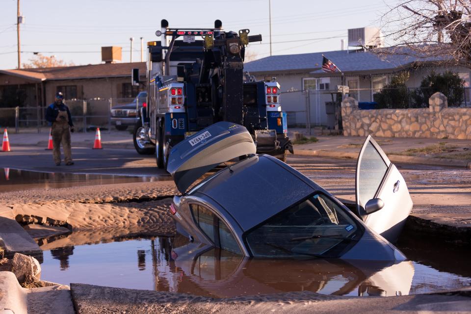 A car fell into a sinkhole after a coupling connecting two sections of water pipeline failed in the 700 block of Feliz Place in South-Central El Paso on Tuesday. No injuries were reported.