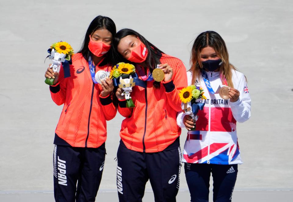 Medalists from left Kokona Hiraki (JPN), Sakura Yosozumi (JPN) and Sky Brown (GBR) with their medals after the women's skateboarding park final during the Tokyo 2020 Olympic Summer Games at Ariake Urban Sports Park.