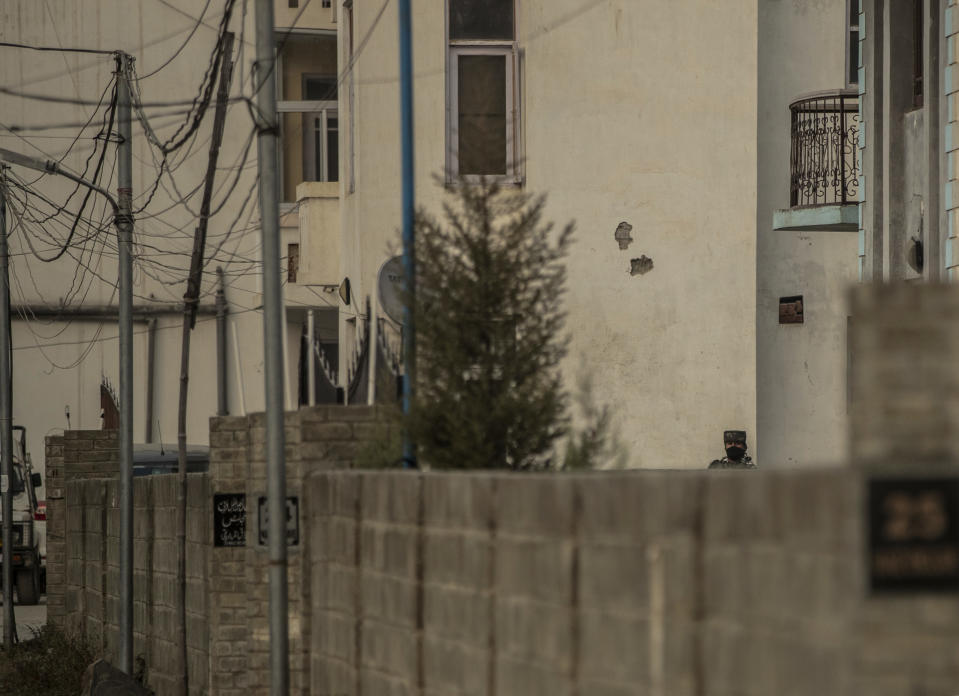 An Indian paramilitary soldier stands guard as National Investigation Agency personnel search the premises of Agence France-Presse’s Kashmir correspondent Parvaiz Bukhari on the outskirts of Srinagar, Indian controlled Kashmir, Wednesday, Oct. 28, 2020. (AP Photo/Mukhtar Khan)