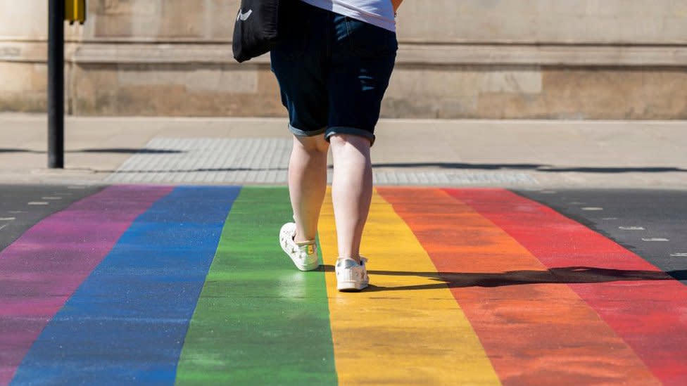 Person walking over the rainbow crossing in Battersea