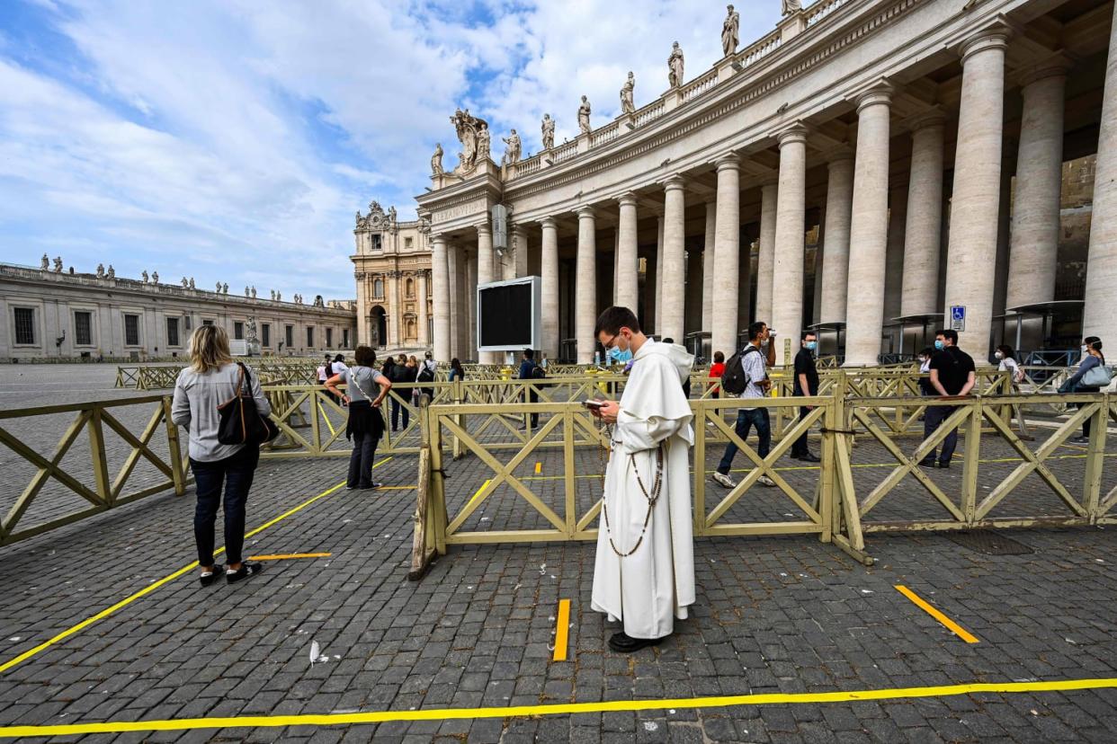 Image: People line up in respect of security distancing to access St. Peter's Basilica on May 18, 2020 in The Vatican during the lockdown aimed at curbing the spread of the COVID-19 infection, caused by the novel coronavirus. (Vincnenzo Pinto / AFP - Getty Images)
