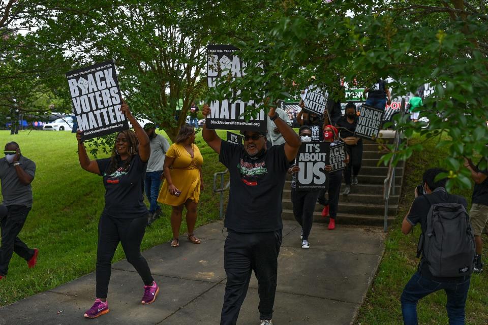 Black Voters Matter demonstrators march during a voting rights rally on June 19, 2021, in Jackson, Miss. <a href="https://www.gettyimages.com/detail/news-photo/latosha-brown-and-cliff-albright-co-founders-of-black-news-photo/1233659782?phrase=mississippi%20voting&adppopup=true" rel="nofollow noopener" target="_blank" data-ylk="slk:Joshua Lott/The Washington Post via Getty Images;elm:context_link;itc:0;sec:content-canvas" class="link ">Joshua Lott/The Washington Post via Getty Images</a>