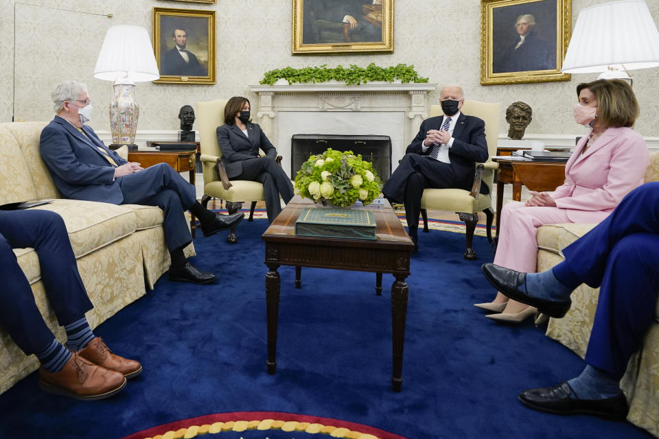 FILE - In this May 12, 2021, file photo President Joe Biden speaks during a meeting with congressional leaders in the Oval Office of the White House in Washington. From left, House Minority Leader Kevin McCarthy of Calif., Senate Minority Leader Mitch McConnell of Ky., Vice President Kamala, Biden, House Speaker Nancy Pelosi of Calif., and Senate Majority Leader Chuck Schumer of N.Y. (AP Photo/Evan Vucci, File)